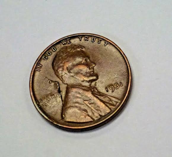 1931 wheat penny lamination error showing peeling surface metal across the obverse